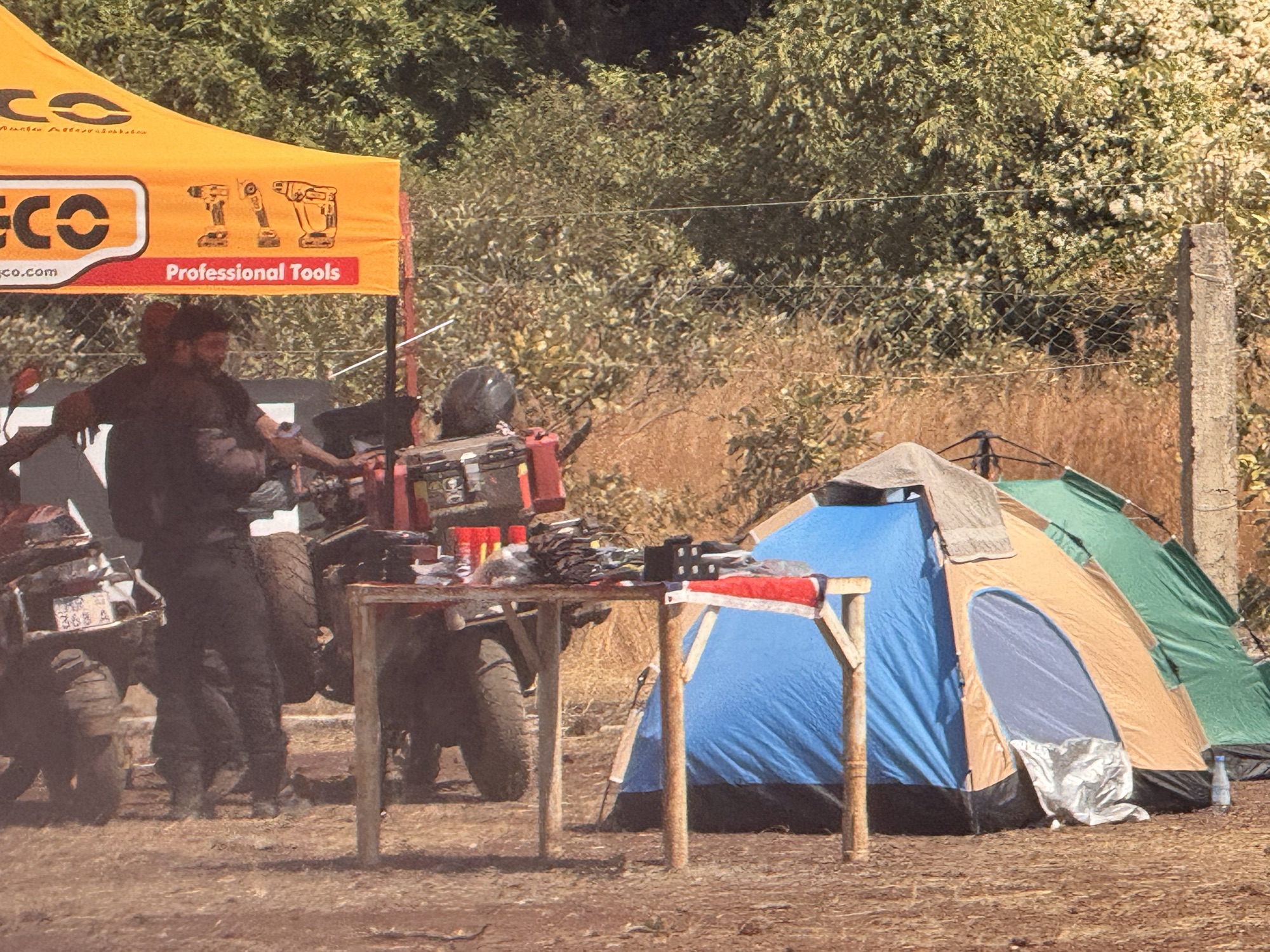 Bivouac at night with riders' tents and adventure bikes